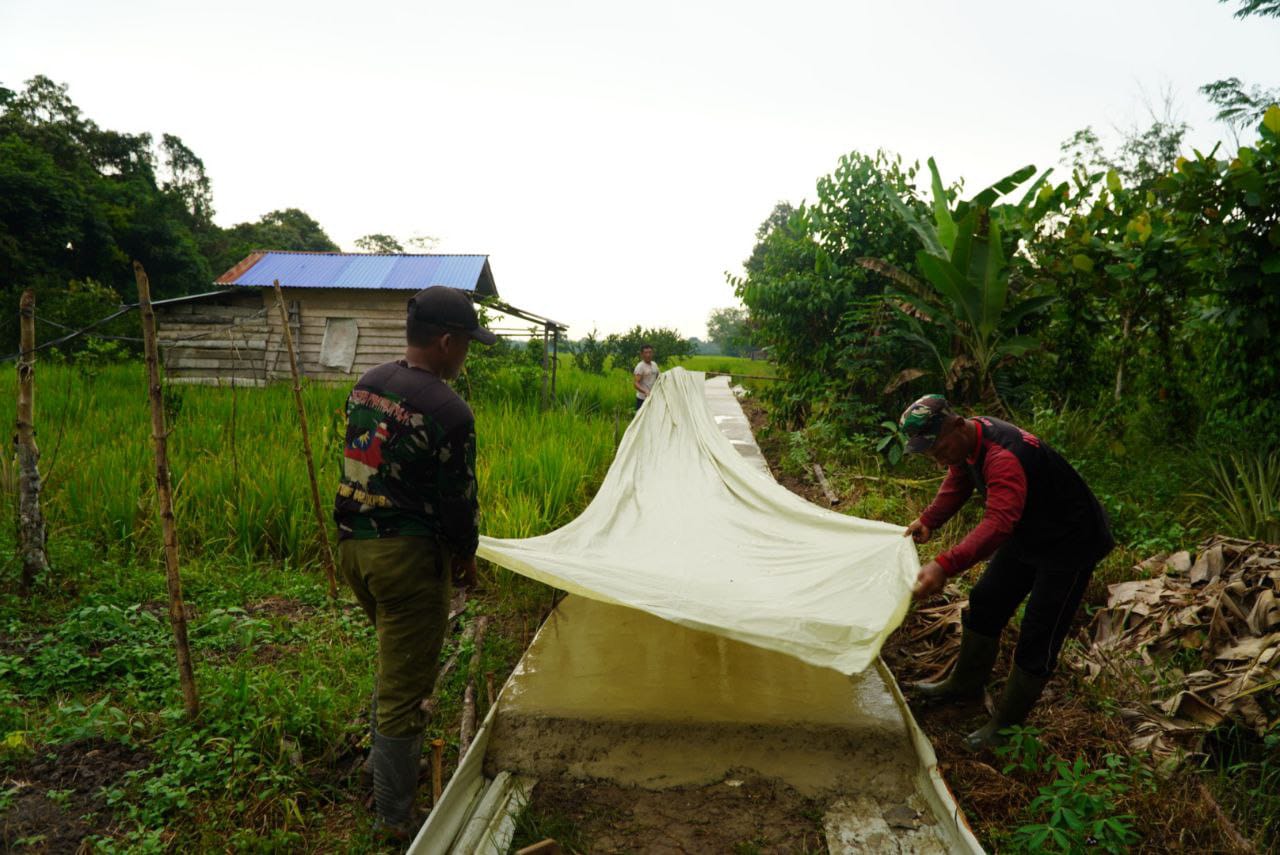 Satgas TMMD ke-126 Kodim Sambas Tutup Coran Beton Pakai Plastik, Antisipasi Hujan